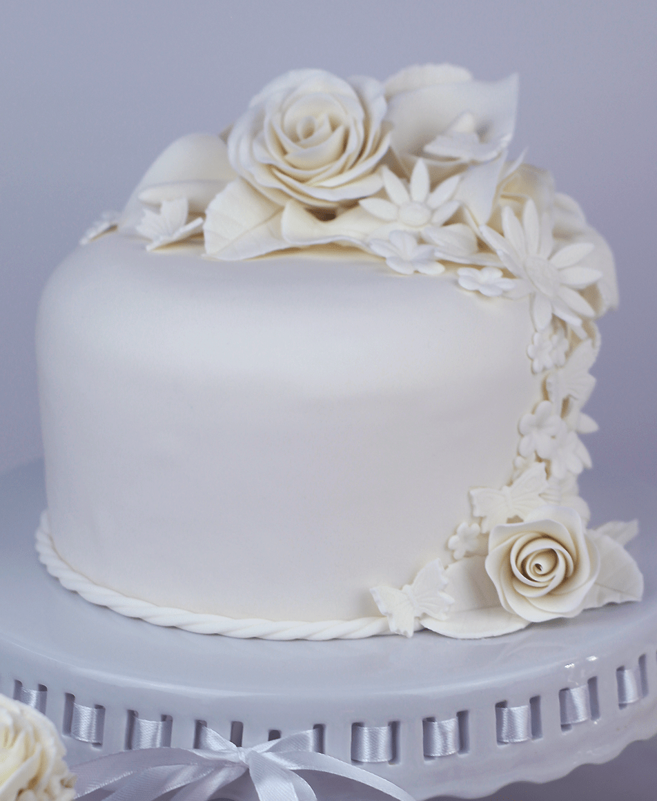 Pure white single tiered cake with cascading gum paste flowers